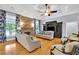 Spacious living room featuring a stone fireplace, hardwood floors, and abundant natural light, perfect for relaxation at 130 Holly Reserve Pkwy, Canton, GA 30114