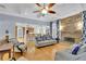 Cozy living room with a stone fireplace, hardwood floors, and stylish furniture creating a comfortable retreat at 130 Holly Reserve Pkwy, Canton, GA 30114