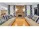 Cozy living room featuring a stone fireplace, hardwood floors, and stylish decor at 130 Holly Reserve Pkwy, Canton, GA 30114