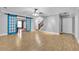 Open-concept living room with hardwood floors, blue barn doors, and staircase in the background at 130 Holly Reserve Pkwy, Canton, GA 30114