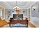 Stylish home office featuring custom built-ins, hardwood floors, and ample natural light at 130 Holly Reserve Pkwy, Canton, GA 30114