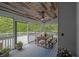 Cozy screened porch with a wooden ceiling, dining table, and peaceful views of nature at 130 Holly Reserve Pkwy, Canton, GA 30114