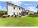 Spacious backyard with a patio, grill, dining set, and screened-in porch at 2213 Independence Ln, Buford, GA 30519