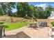 Inviting backyard with a cozy patio featuring a dining set and grill, perfect for outdoor entertaining at 2213 Independence Ln, Buford, GA 30519