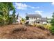 Picturesque backyard with benches, a lush lawn, and views of the home's exterior at 2213 Independence Ln, Buford, GA 30519