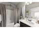 Well-lit bathroom with a shower and tub, along with decoratively framed mirror and vanity at 2213 Independence Ln, Buford, GA 30519