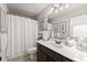 Bright bathroom featuring a shower and tub, with a large vanity and decoratively framed mirror at 2213 Independence Ln, Buford, GA 30519