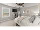 Bright bedroom featuring a ceiling fan, closet, and window providing natural light at 2213 Independence Ln, Buford, GA 30519