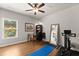 Bright bedroom with a desk, exercise equipment, a large mirror, and a view of the outdoors at 2213 Independence Ln, Buford, GA 30519