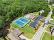 Aerial view featuring community amenities with tennis courts and swimming pool surrounded by lush greenery at 2213 Independence Ln, Buford, GA 30519