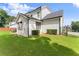Well-maintained home exterior featuring a white siding, dark roof, and manicured lawn at 2213 Independence Ln, Buford, GA 30519