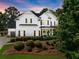 Stunning two-story home with a white exterior, black shutters, and beautifully landscaped front yard at 2213 Independence Ln, Buford, GA 30519