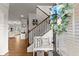 Inviting foyer featuring wood floors, decorative wreath, and a staircase leading to the upper level at 2213 Independence Ln, Buford, GA 30519