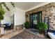 Charming covered front porch featuring stone accents, potted plants, and stylish outdoor seating at 2213 Independence Ln, Buford, GA 30519