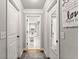 A hallway shows white paneled doors, with a view to the living room at 2213 Independence Ln, Buford, GA 30519