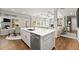 Open-concept kitchen showcases an island, stainless steel appliances and seamless access to the living and dining area at 2213 Independence Ln, Buford, GA 30519