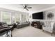 Inviting living room filled with natural light, comfortable seating, and modern entertainment center at 2213 Independence Ln, Buford, GA 30519