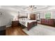 Serene primary bedroom boasts hardwood floors, a tray ceiling, and comfortable decor at 2213 Independence Ln, Buford, GA 30519