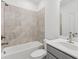 Bright bathroom featuring a shower-tub combo and a light gray vanity at 377 Danville Ave, Suwanee, GA 30024