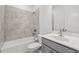 Bright bathroom featuring a shower-tub combo and a gray vanity at 377 Danville Ave, Suwanee, GA 30024