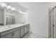 Modern bathroom with double vanity, large mirror, modern lighting, and a glass-enclosed shower at 377 Danville Ave, Suwanee, GA 30024