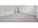 Spacious bedroom features neutral carpet, light walls and two entry doors at 377 Danville Ave, Suwanee, GA 30024