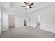 Large carpeted bedroom with a ceiling fan with views to the ensuite bath and walk-in closet at 377 Danville Ave, Suwanee, GA 30024