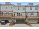 Townhome rear exterior featuring private decks and garage parking at 377 Danville Ave, Suwanee, GA 30024