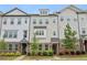 Charming townhome features brick accents, stylish siding, and professionally landscaped front yard at 377 Danville Ave, Suwanee, GA 30024
