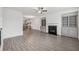 Bright living room featuring gray wood floors, fireplace, built-in cabinets, and an open concept at 377 Danville Ave, Suwanee, GA 30024