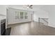 Spacious living room with wood floors, large windows, and adjacent access to the outdoor area at 377 Danville Ave, Suwanee, GA 30024