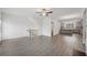 Open-concept living space with wood floors, fireplace, and staircase, leading to the kitchen at 377 Danville Ave, Suwanee, GA 30024