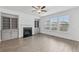 Living room featuring wood floors, fireplace, and built-in cabinets, illuminated by natural light at 377 Danville Ave, Suwanee, GA 30024