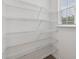 Walk-in pantry with window and adjustable wire shelving at 377 Danville Ave, Suwanee, GA 30024
