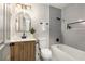 Modern bathroom with stylish vanity, arched mirror, and tiled shower over tub at 515 Dover St, Marietta, GA 30066