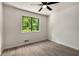 Neutral bedroom features a modern ceiling fan and a tree-lined view through window at 515 Dover St, Marietta, GA 30066
