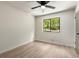 Neutral bedroom features a modern ceiling fan and tree-lined view through window at 515 Dover St, Marietta, GA 30066