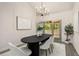 Dining area featuring modern chandelier, open layout and view to screened porch at 515 Dover St, Marietta, GA 30066