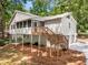 Exterior showcasing a raised two-story home with a back porch overlooking the private wooded lot at 515 Dover St, Marietta, GA 30066