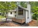 Stunning exterior featuring a modern design, accented by a cozy deck and lush foliage at 515 Dover St, Marietta, GA 30066