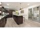 Open kitchen boasts granite counters, stainless appliances, and island seating with french doors at 515 Dover St, Marietta, GA 30066