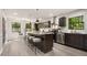 Beautiful kitchen with dark cabinetry, granite countertops, stainless appliances, and island seating at 515 Dover St, Marietta, GA 30066