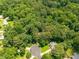 Aerial view shows the wooded surroundings, cul-de-sac, and nearby homes at 5848 Kingswood Ct, Norcross, GA 30093