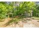 The secluded backyard is perfect for outdoor activities, featuring an arbor and mature trees at 5848 Kingswood Ct, Norcross, GA 30093