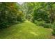 Beautiful backyard with lush greenery and manicured lawn at 5848 Kingswood Ct, Norcross, GA 30093