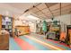 Open basement area with colorful flooring, a bar, and storage solutions, offering a flexible space for various purposes and hobbies at 5848 Kingswood Ct, Norcross, GA 30093