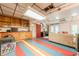 Multipurpose basement area with storage, workspace, seating, and colorful floors, providing a versatile and functional living space at 5848 Kingswood Ct, Norcross, GA 30093