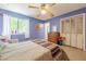Comfortable bedroom with a ceiling fan, closet, light, window, dresser and woven furniture, offering comfort and functionality at 5848 Kingswood Ct, Norcross, GA 30093