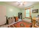 A well-lit bedroom with light green walls and hard surface floors at 5848 Kingswood Ct, Norcross, GA 30093