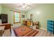 A well-lit bedroom with light green walls and hard surface floors at 5848 Kingswood Ct, Norcross, GA 30093